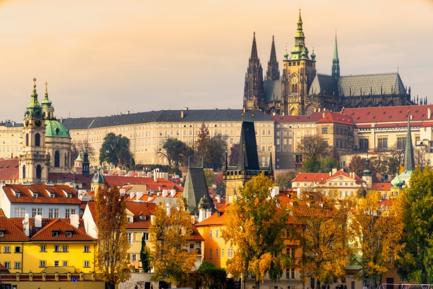 Lâu đài Prague với khung cảnh cổ kính và những mái nhà đỏ nổi bật trên nền trời xanh.