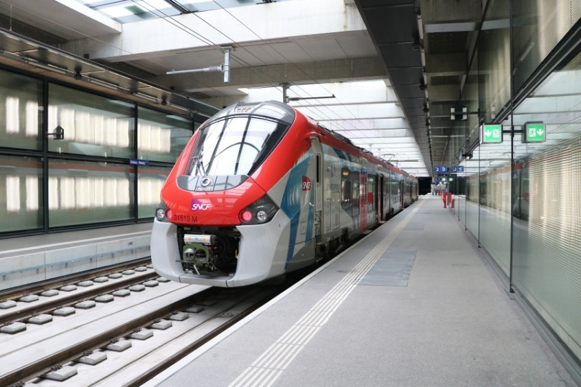 Tàu điện SBB CFF FFS hiện đại màu đỏ trắng tại nhà ga Geneva, với kiến trúc kính