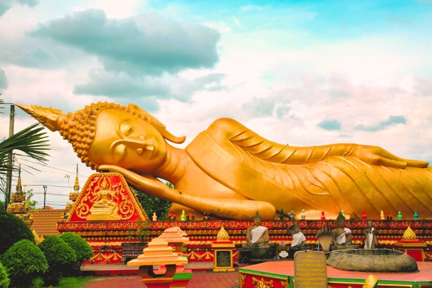 Tượng Phật nằm dát vàng ở Vientiane, Lào với kiến trúc đền chùa truyền thống tại Thạt Luổng (That Luang Stupa)