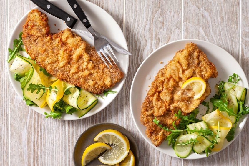 Miếng Milanesa chiên giòn, bày cùng lát chanh tươi