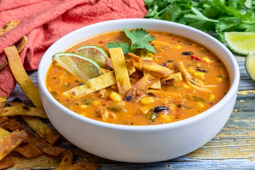 Súp tortilla Mexico với lát tortilla, rau thơm và sốt cay nhẹ đặc trưng